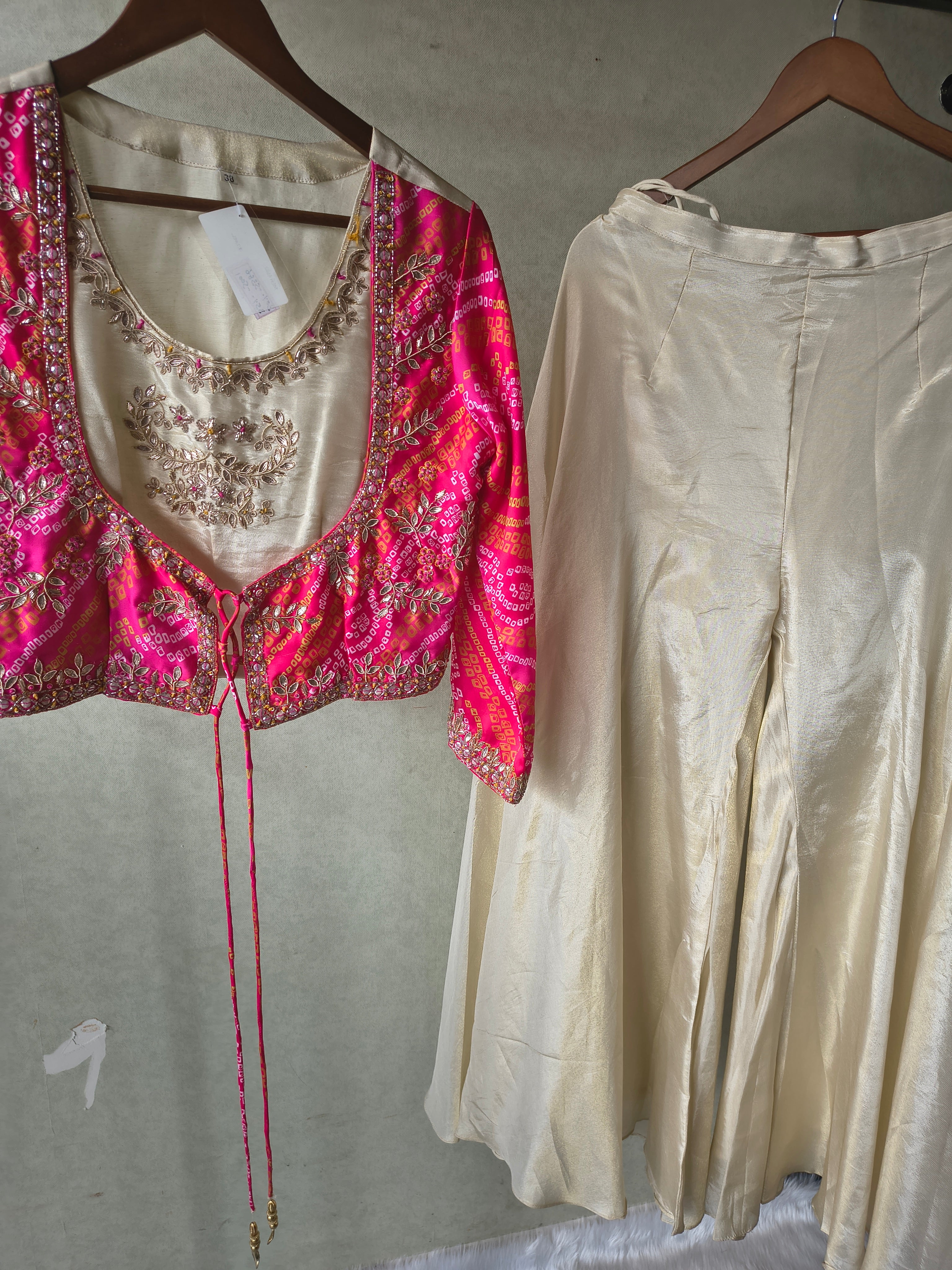 Image of Premium Hot Pink Bandhani Print Embroidered Jacket Blouse with Ivory Flared Palazzo Set