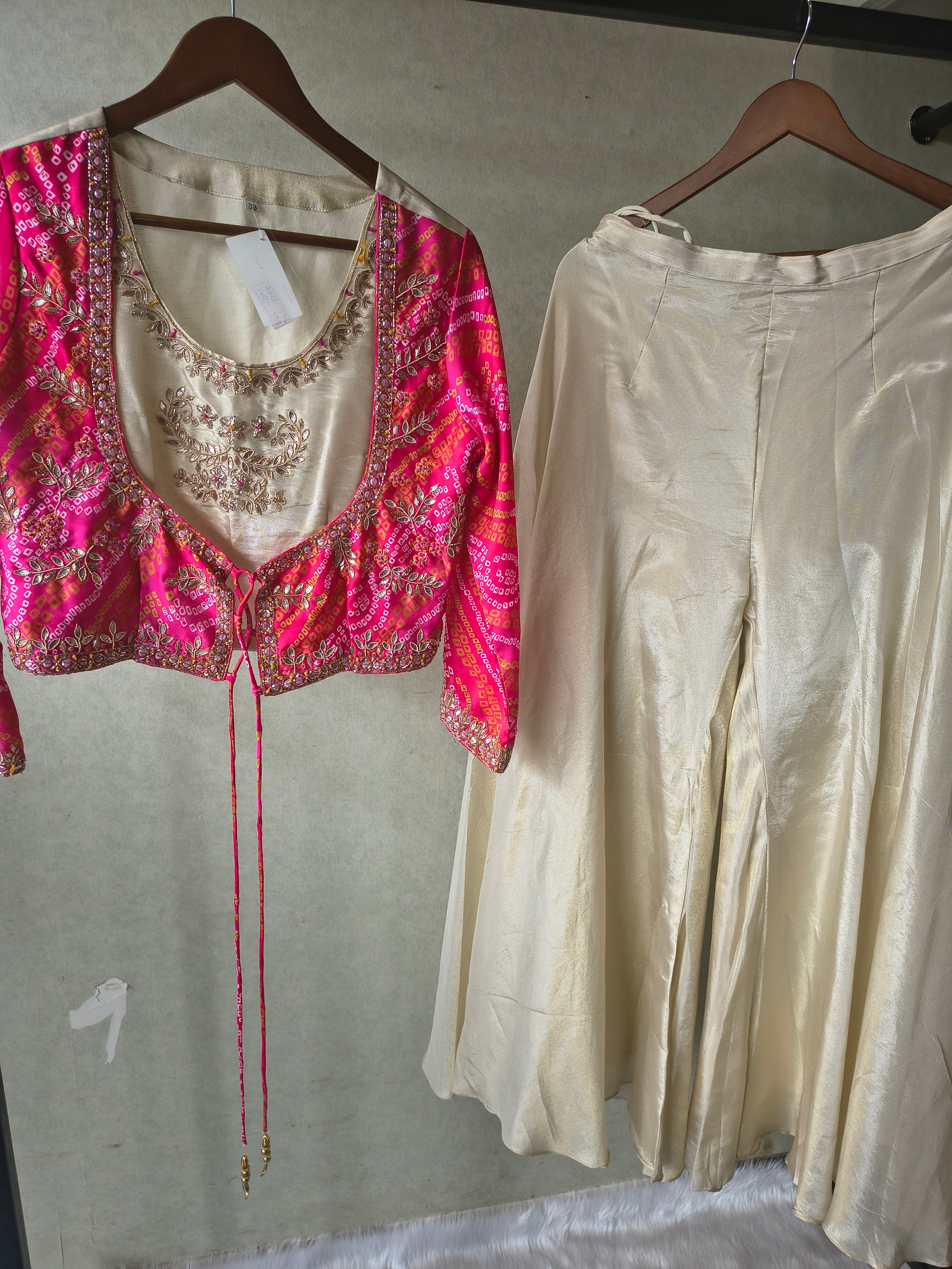 Image of Premium Hot Pink Bandhani Print Embroidered Jacket Blouse with Ivory Flared Palazzo Set